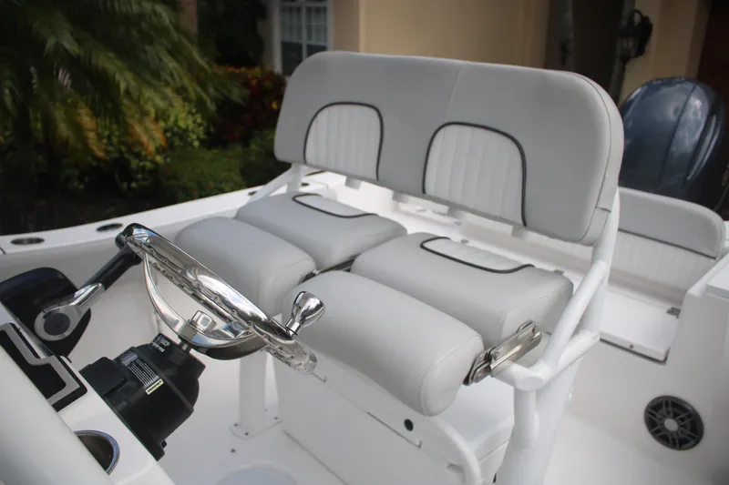 Slide: The Image of 2023 Sea Fox 228 boat interior with dual cushioned seats and steering wheel. - 23