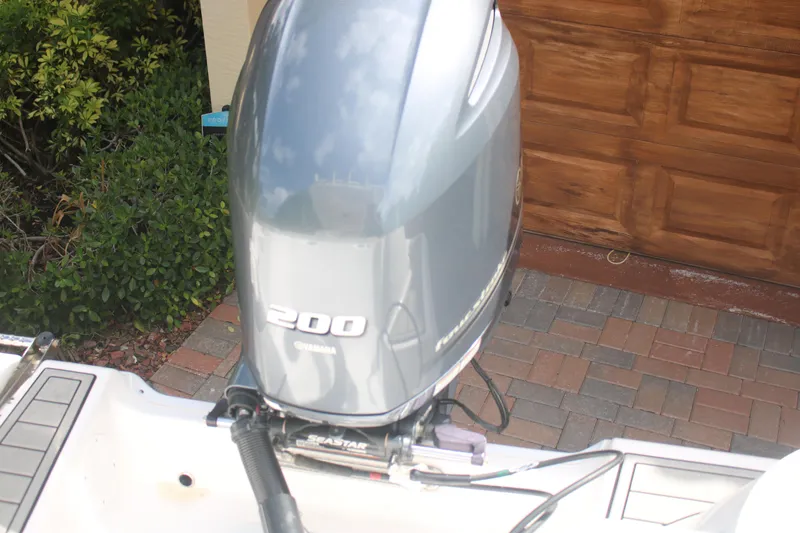 Slide: The Image of 2023 Sea Fox 228 boat with a 200 horsepower outboard motor, parked on a brick driveway. - 7