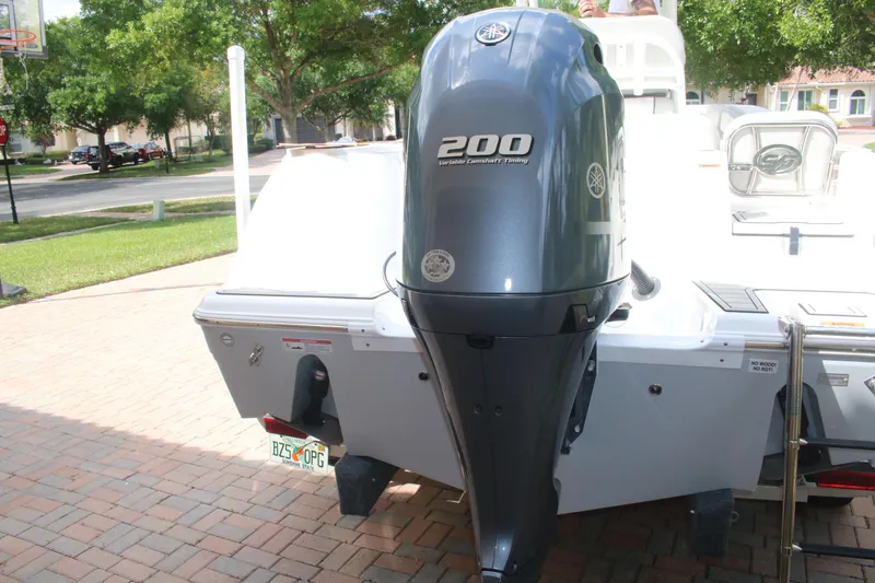 Slide: The Image of 2023 Sea Fox 228 boat with Yamaha 200 outboard engine, parked on brick driveway. - 8