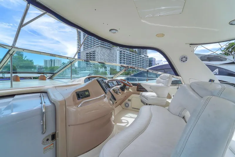Slide: The Image of 2004 Sea Ray 460 Sundancer yacht interior with modern helm and luxurious seating. - 14