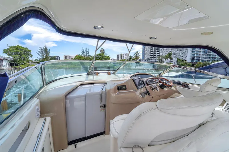 Slide: The Image of 2004 Sea Ray 460 Sundancer yacht cockpit with luxurious seating and modern controls. - 15
