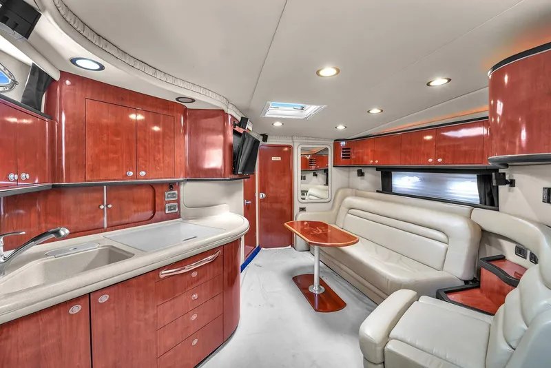 Slide: The Image of Luxurious interior of 2004 Sea Ray 460 Sundancer yacht with elegant wood cabinetry and plush seating. - 19