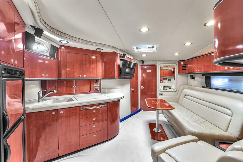 Slide: The Image of Luxurious interior of 2004 Sea Ray 460 Sundancer yacht with modern kitchen and seating area. - 20
