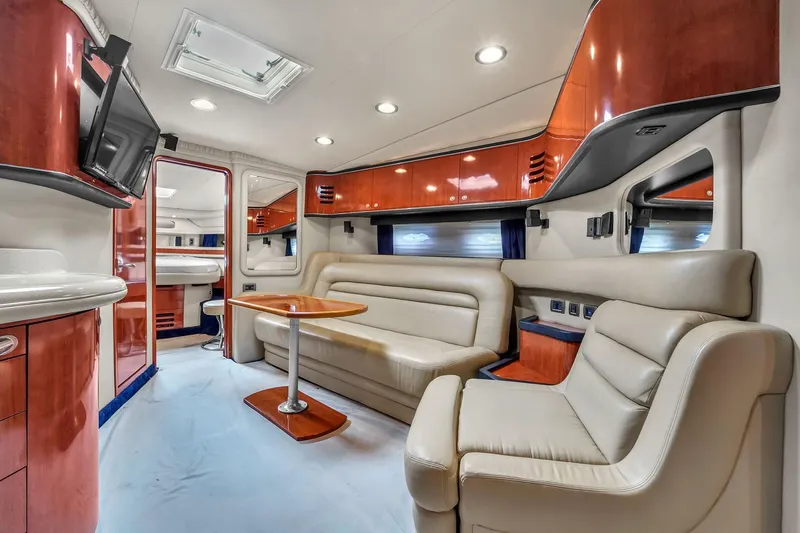 Slide: The Image of Luxurious interior of 2004 Sea Ray 460 Sundancer yacht with leather seating and wood accents. - 21