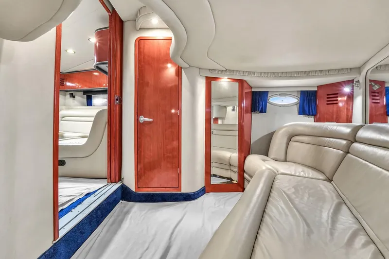 Slide: The Image of 2004 Sea Ray 460 Sundancer interior with beige leather seating and wooden accents. - 28