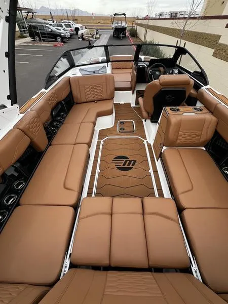 Slide: The Image of 2025 Malibu 24 MXZ boat interior with luxurious tan seating and modern design. - 15