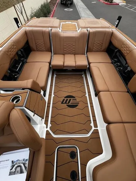 Slide: The Image of Luxurious interior of 2025 Malibu 24 MXZ boat with tan leather seating. - 17