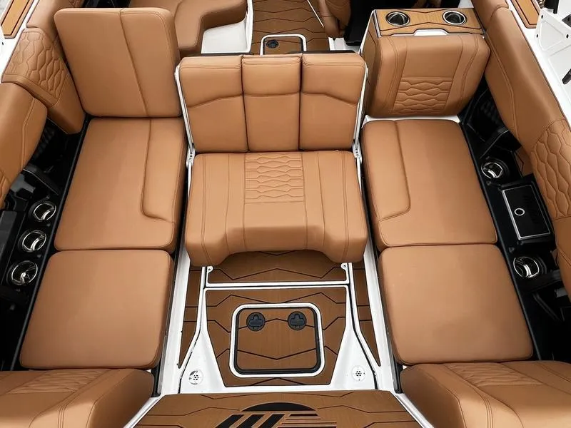 Slide: The Image of Luxurious interior of 2025 Malibu 24 MXZ boat with tan leather seating and cup holders. - 28