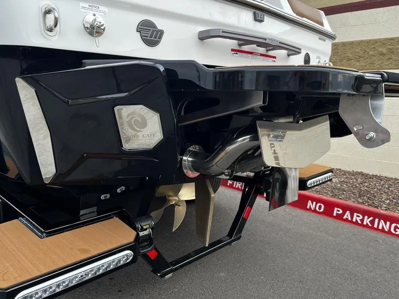 Slide: The Image of 2025 Malibu 24 MXZ boat rear view, featuring propeller and swim platform details. - 4