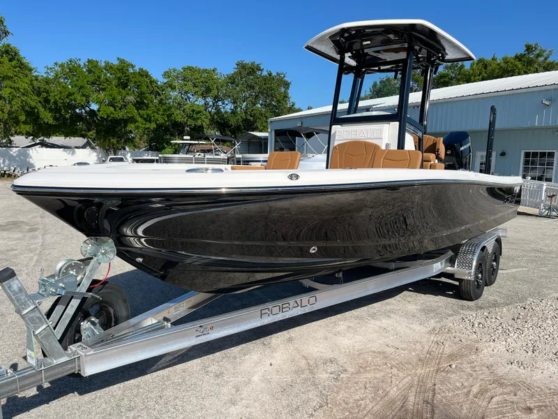 Slide: The Image of 2025 Robalo 246 Cayman boat on trailer, sleek design, parked outdoors. - 3