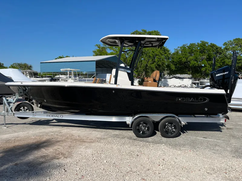 Slide: The Image of 2025 Robalo 246 Cayman boat on trailer, black hull, outdoor setting. - 4