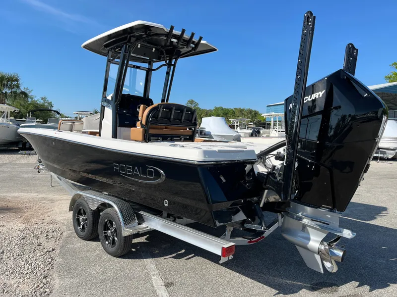 Slide: The Image of 2025 Robalo 246 Cayman boat on trailer, featuring sleek black design and powerful outboard motor. - 5