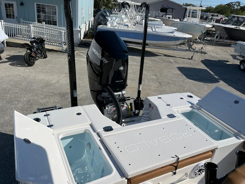 Slide: The Image of 2025 Robalo 246 Cayman boat with outboard motor and open storage compartments. - 8