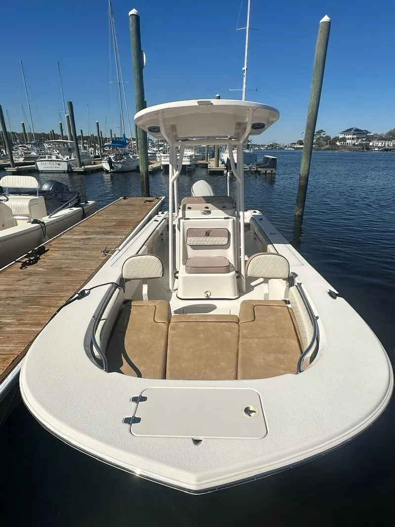 Slide: The Image of 2023 Carolina Skiff 24 Ultra Elite boat docked at a marina. - 10