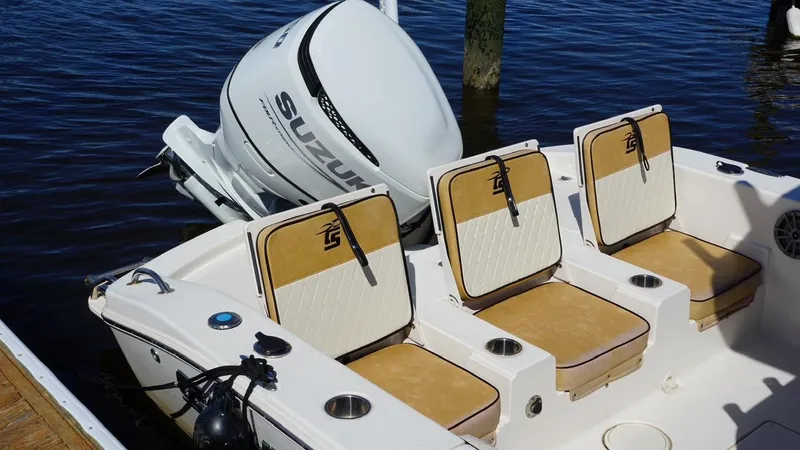 Slide: The Image of 2023 Carolina Skiff 24 Ultra Elite boat with Suzuki outboard motor and cushioned seating. - 3