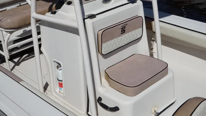 Slide: The Image of 2023 Carolina Skiff 24 Ultra Elite boat interior with cushioned seating and safety equipment. - 5