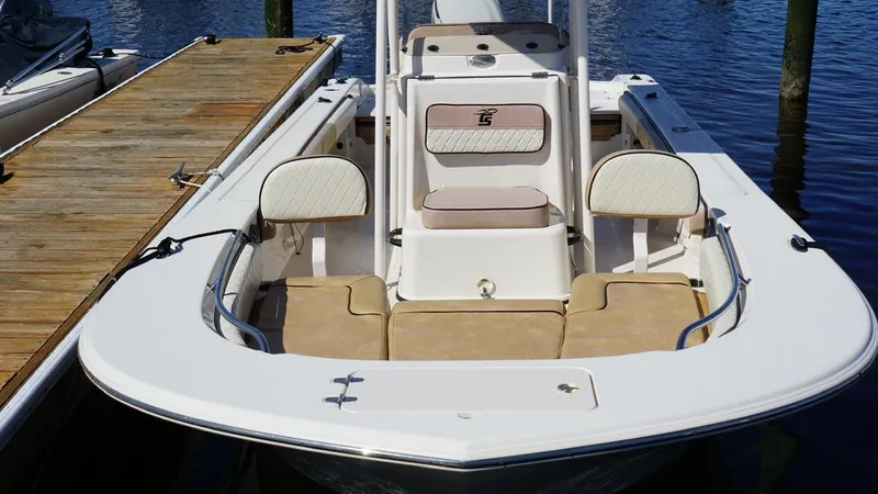 Slide: The Image of 2023 Carolina Skiff 24 Ultra Elite boat docked, showcasing spacious seating and sleek design. - 6