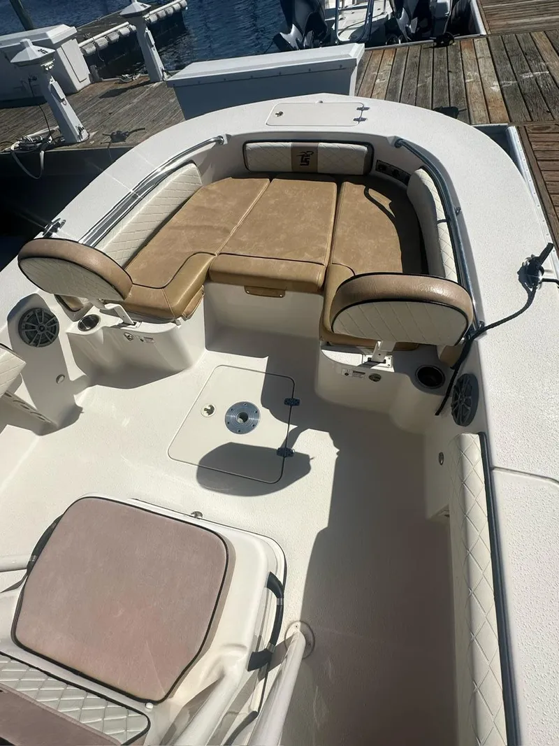 Slide: The Image of 2023 Carolina Skiff 24 Ultra Elite boat interior with tan seating and white deck. - 7