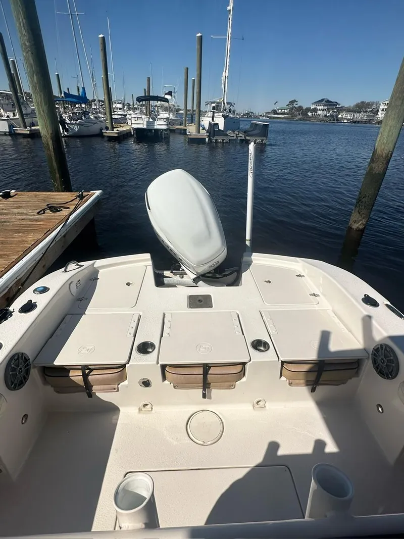 Slide: The Image of 2023 Carolina Skiff 24 Ultra Elite boat docked at a marina. - 8