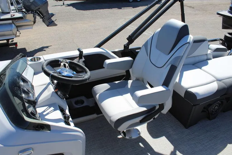 Slide: The Image of 2025 Avalon LSZ 2185 Quad Lounge Shift boat interior with modern seating and steering console. - 13