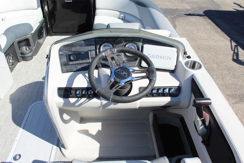 Slide: The Image of 2025 Avalon LSZ 2185 Quad Lounge Shift boat dashboard with steering wheel and Garmin display. - 19