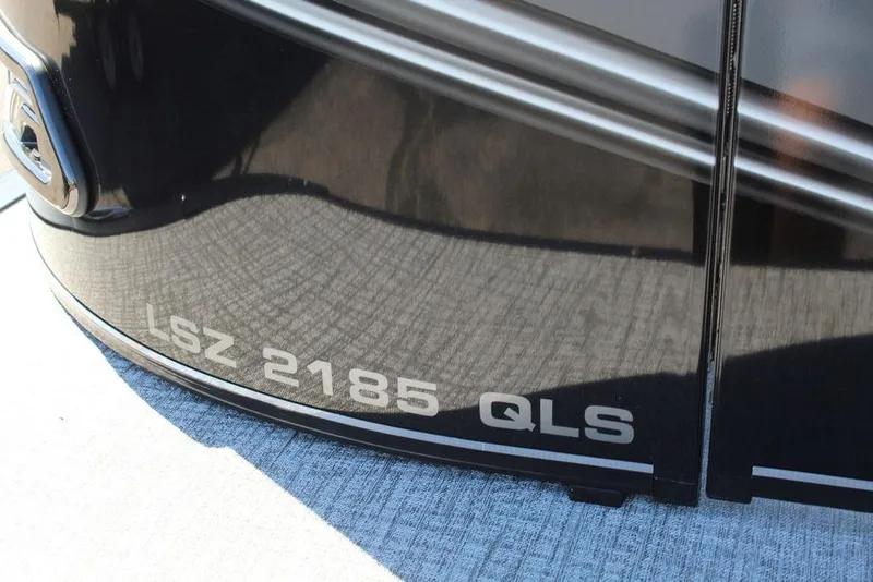 Slide: The Image of 2025 Avalon LSZ 2185 QLS boat model name on sleek black surface. - 22