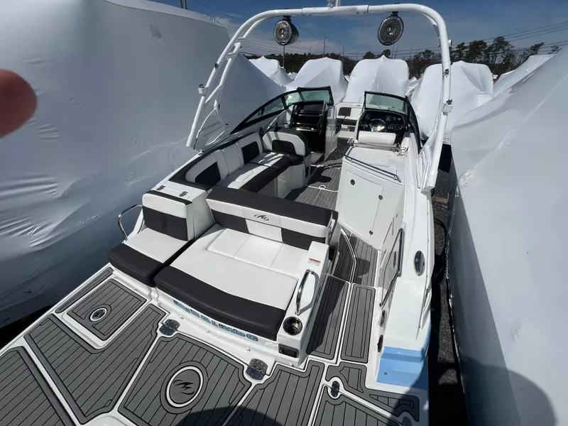 Slide: The Image of 2022 Monterey M65 boat with sleek seating and modern design, docked and covered. - 10