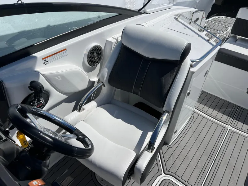 Slide: The Image of Captain's seat and helm of 2022 Monterey M65 boat, featuring sleek design and modern controls. - 18