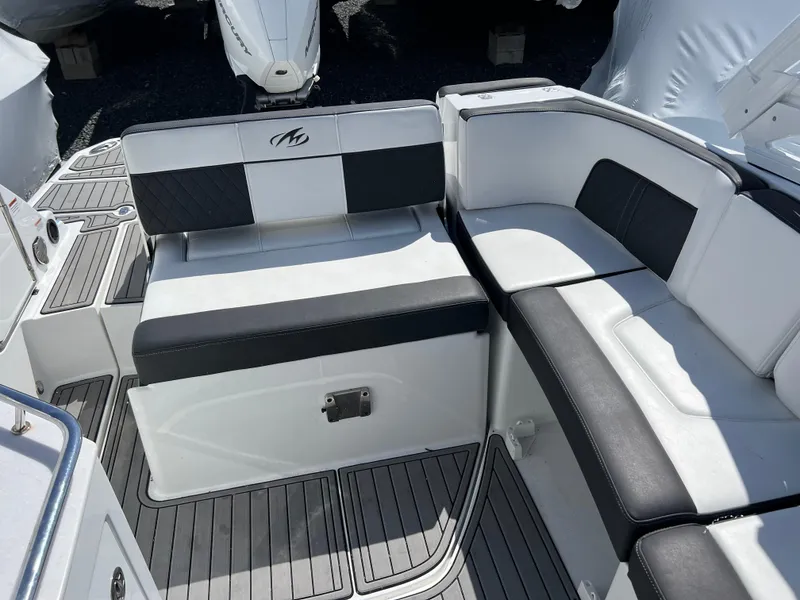 Slide: The Image of 2022 Monterey M65 boat interior with black and white seating and sleek design. - 19