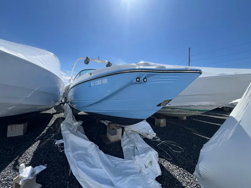 Slide: The Image of 2022 Monterey M65 boat in storage, covered and elevated on blocks. - 3