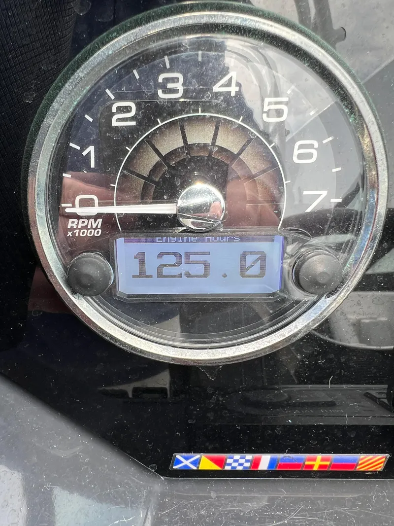 Slide: The Image of Tachometer of 2022 Monterey M65 showing 125 RPM with nautical flags below. - 5