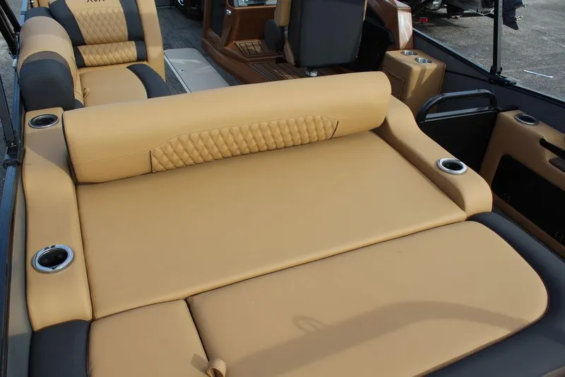 Slide: The Image of 2025 Avalon Catalina Versatile Rear Bench 23 FT with luxurious tan seating and cup holders. - 25