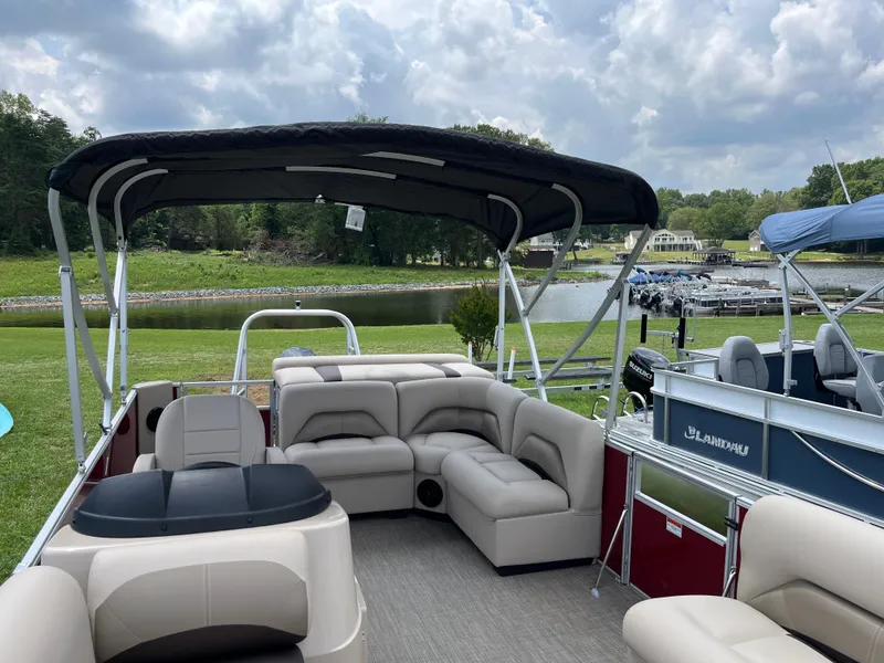 Slide: The Image of 2024 Landau Island Breeze 232 Cruise pontoon boat with spacious seating and canopy. - 9