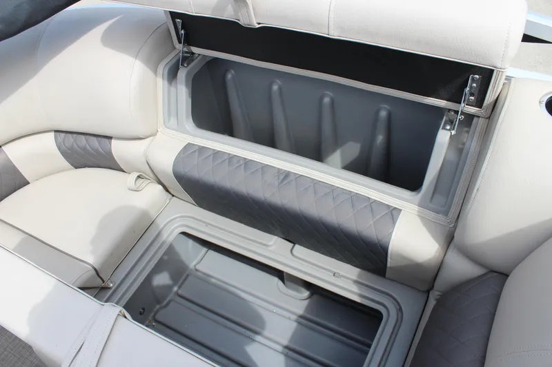 Slide: The Image of 2023 Sun Tracker Party Barge 22 DLX storage compartment with cushioned seating. - 18