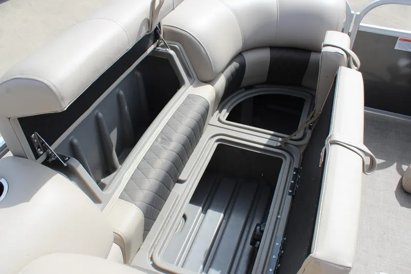 Slide: The Image of 2023 Sun Tracker Party Barge 22 DLX interior storage compartments with cushioned seating. - 21