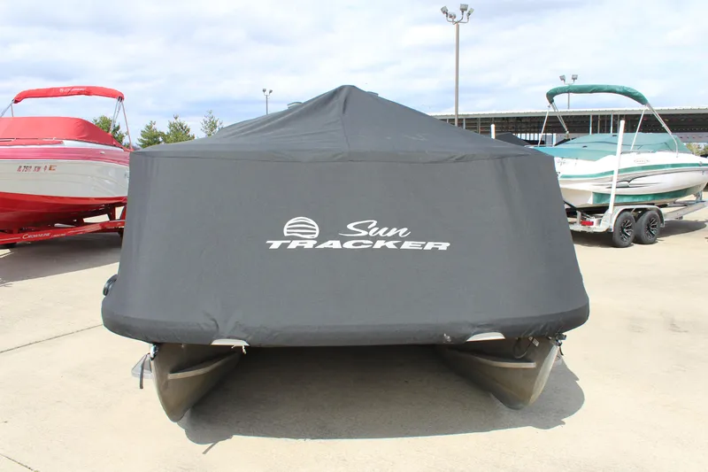 Slide: The Image of 2023 Sun Tracker Party Barge 22 DLX covered, parked on concrete. - 24