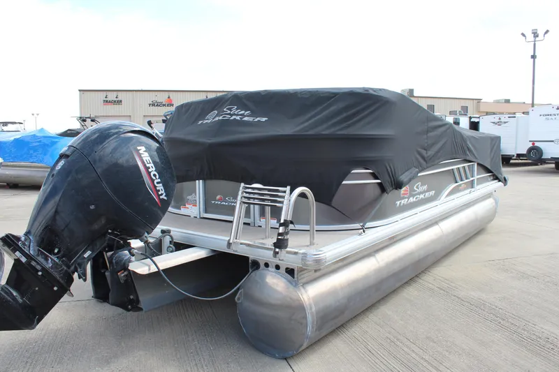 Slide: The Image of 2023 Sun Tracker Party Barge 22 DLX pontoon boat with Mercury outboard engine, covered and docked. - 27