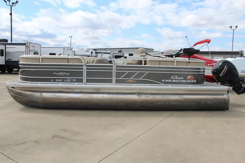Slide: The Image of 2023 Sun Tracker Party Barge 22 DLX pontoon boat on display outdoors. - 3