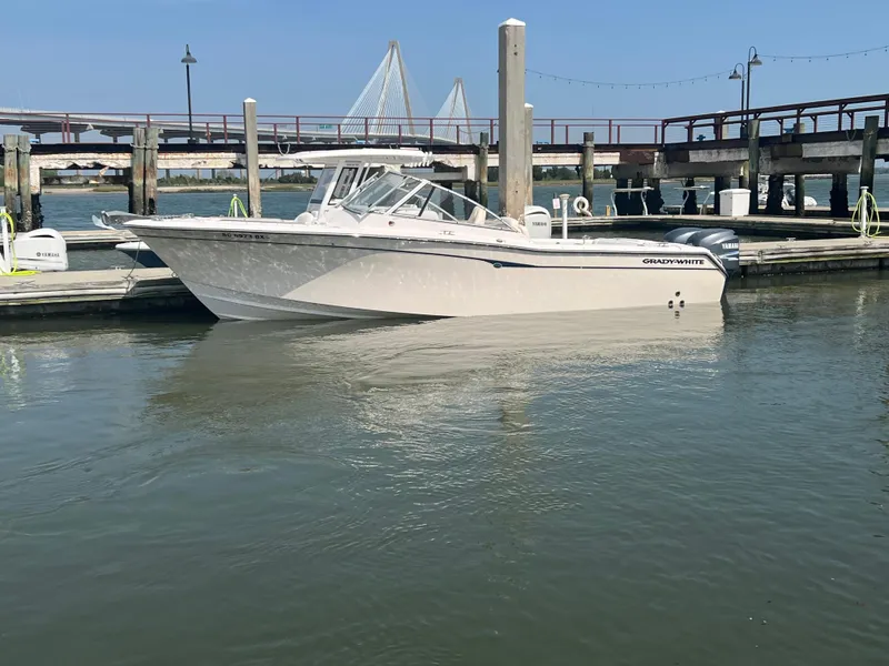 Slide: The Image of 2007 Grady-White Tournament 275 boat docked at a marina with bridge in background. - 0