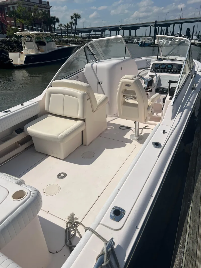 Slide: The Image of 2007 Grady-White Tournament 275 boat docked, featuring spacious seating and helm, under clear skies. - 18