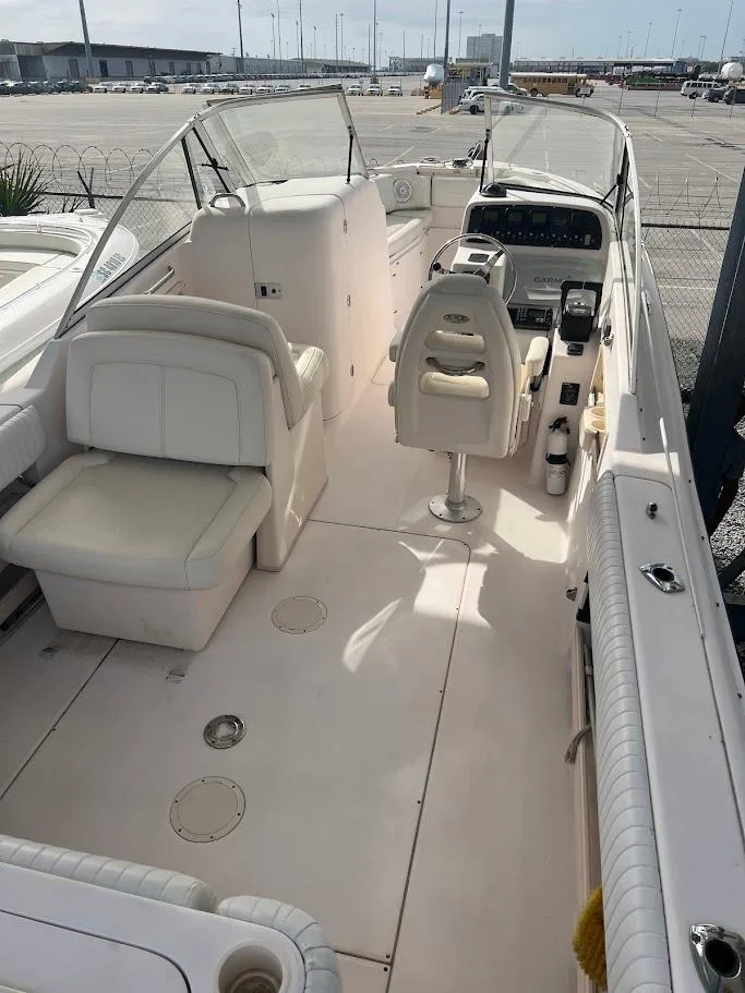 Slide: The Image of 2007 Grady-White Tournament 275 boat interior with seating and helm, docked at marina. - 22