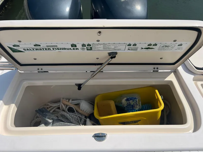 Slide: The Image of Open storage compartment on 2007 Grady-White Tournament 275 boat with fishing gear. - 23