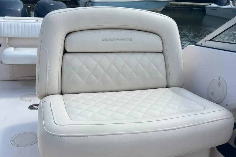 Slide: The Image of 2007 Grady-White Tournament 275 boat seat with quilted white upholstery. - 8