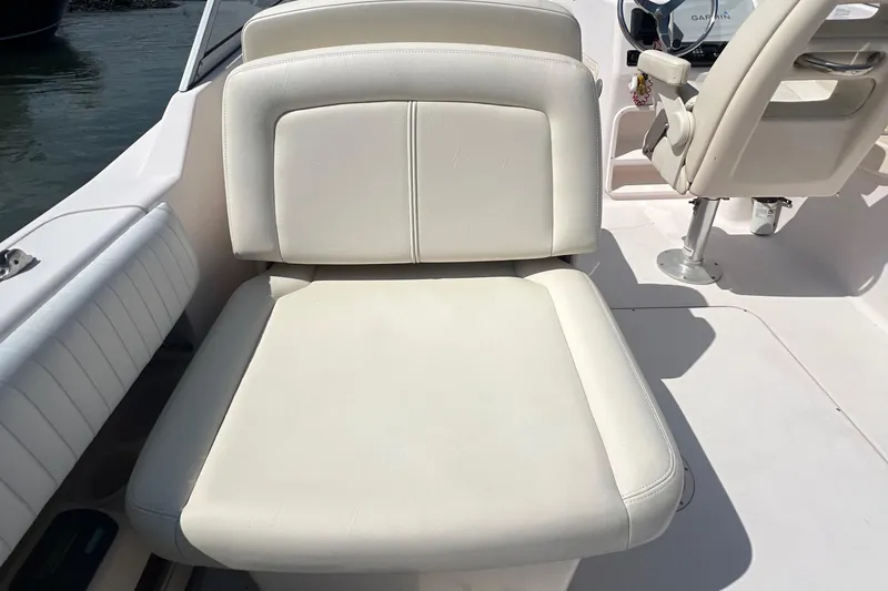 Slide: The Image of 2007 Grady-White Tournament 275 boat seat, white upholstery, on deck. - 9