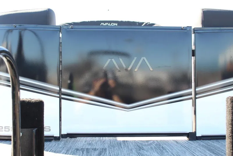 Slide: The Image of 2025 Avalon LSZ Quad Lounge Shift 25 FT pontoon boat, sleek design with reflective panels. - 12
