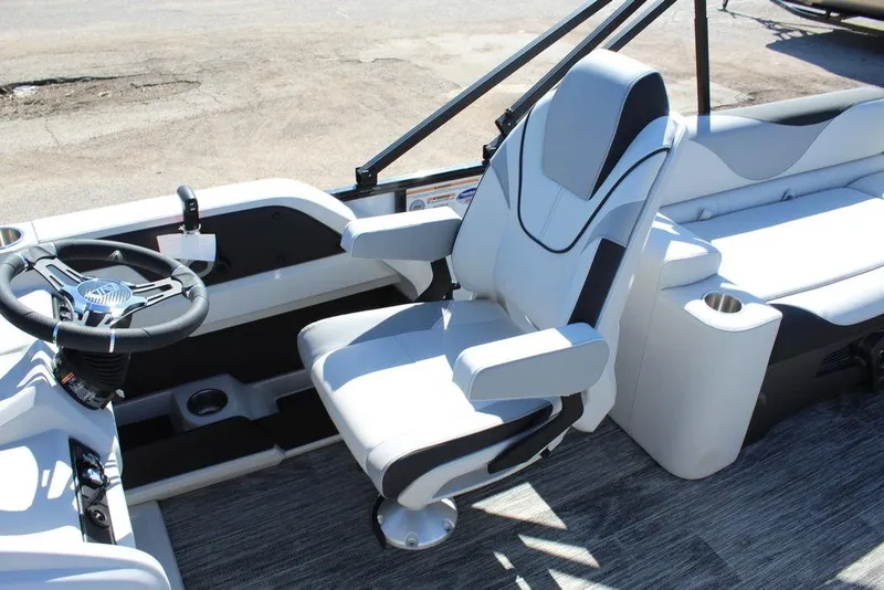 Slide: The Image of 2025 Avalon LSZ Quad Lounge Shift 25 FT boat interior with captain's chair and steering wheel. - 18
