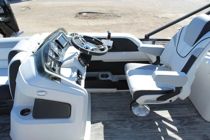 Slide: The Image of 2025 Avalon LSZ Quad Lounge Shift 25 FT boat interior with modern helm and seating. - 19