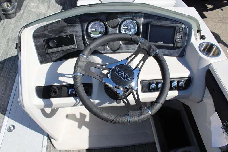 Slide: The Image of 2025 Avalon LSZ Quad Lounge Shift 25 FT boat dashboard with steering wheel and controls. - 20