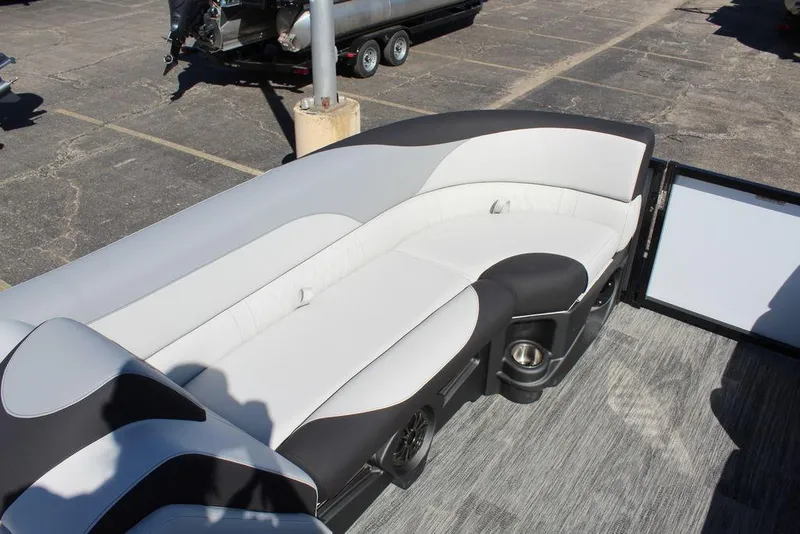 Slide: The Image of 2025 Avalon LSZ Quad Lounge boat interior with sleek seating and cup holders. - 27