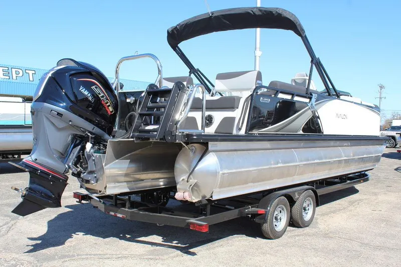 Slide: The Image of 2025 Avalon LSZ Quad Lounge Shift 25 FT pontoon boat on trailer, rear view. - 3
